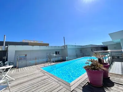 a swimming pool on the roof of a building at Parking + piscine, tout confort, proche aéroport & mer in Saint-Laurent-du-Var