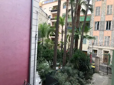 a view of a courtyard with palm trees and buildings at Nice Libération in Nice