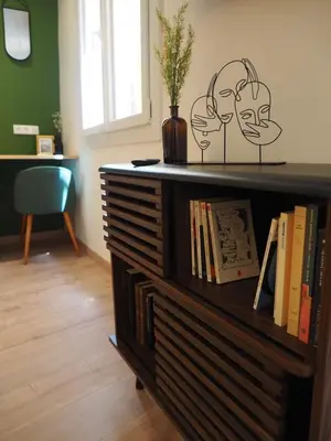 a book shelf with books and a plant on it at 06R - Nice modern apartment - Vieux Nice in Nice