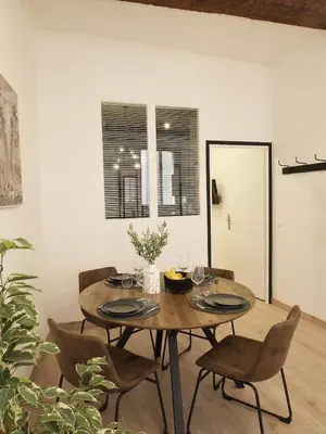 a dining room with a wooden table and chairs at 06R - Nice modern apartment - Vieux Nice in Nice