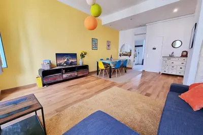 a living room with a blue couch and a table at 