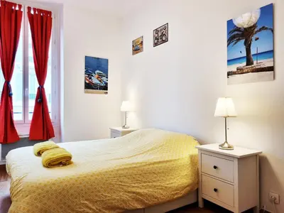 a bedroom with a bed and two lamps and a window at 