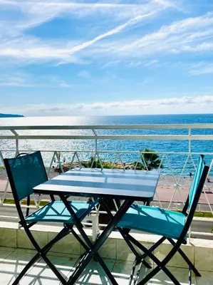 a table and two chairs on a balcony with the ocean at Residence le Florence in Nice