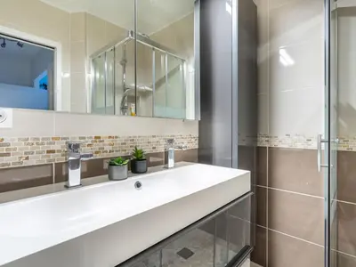 a bathroom with a white sink and a shower at Apartment Le Marbeau-2 by Interhome in Cagnes-sur-Mer