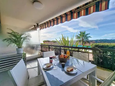 a table with plates of food on top of a balcony at Nestor&Jeeves - GRAND SUD TERRASSE - Pool - Free parking in Nice