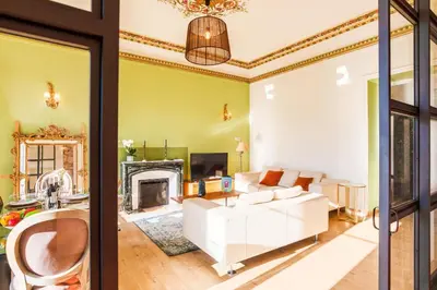 a living room with a white couch and a fireplace at LE PALAZZO AP4329 By Riviera Holiday Homes in Nice