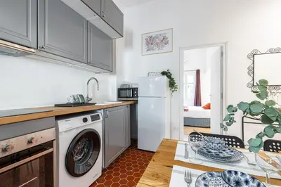 a kitchen with a white refrigerator and a table at Lovely 1 Bdr in Harbor Area in Nice