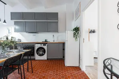 a kitchen with a table and a white refrigerator at Lovely 1 Bdr in Harbor Area in Nice