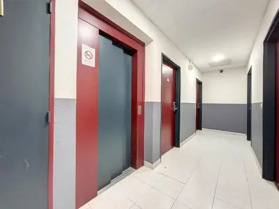 a corridor of an office building with red doors at Nestor&Jeeves - GOLDIE FRANCE RIVIERA - Very close sea in Nice