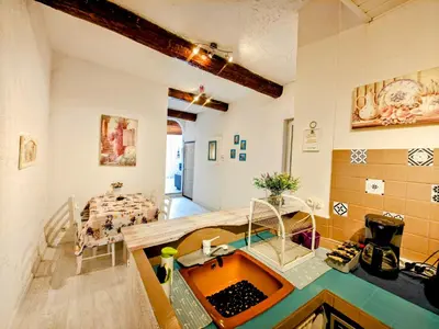 a kitchen with a sink and a table in a room at St Joseph · Great holiday flat - old town for 4 in Nice
