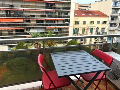 a table and chairs on a balcony with a view at Beachfront Studio on Promenade des Anglais in Nice