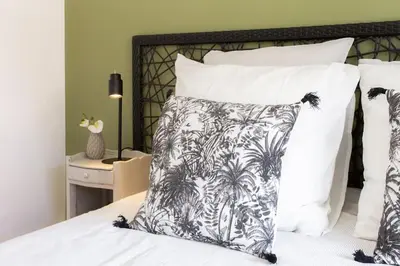 a bed with a black and white pillow on it at #4 Papon Parking climatisé terrasse & wifi 5mins à pieds du Vieux Nice in Nice