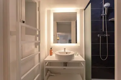 a bathroom with a sink and a mirror and a shower at #8 Suite Promenade 1min Beach 2rooms/Parking/Terrace/WIFI in Nice