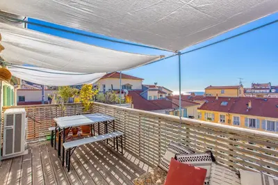 a patio with a table and chairs on a balcony at #9 Opera's Duplex panoramic Sea View Terrace & AC 1min to Beach in Nice