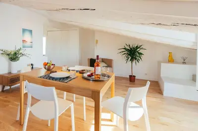 a kitchen with white cabinets and a table and chairs at #32 Panoramic Sea View over Old Town Terrace & AC in Nice
