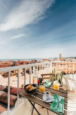 a cactus sitting on the roof of a city at #32 Panoramic Sea View over Old Town Terrace & AC in Nice