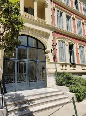 an entrance to a building with a large glass door at Top floor nest, balcony close to sea and old-town Bail Mobilité in Nice