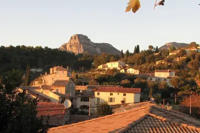 a view of a town with a mountain in the background at Maison de village vue montagne in La Gaude