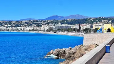 a view of a beach with buildings and the ocean at L'Azur Plaisance in Nice