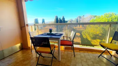 a table and chairs on a balcony with a view at Eden Beach in Cagnes-sur-Mer