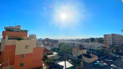 a view of a city with the sun in the sky at La Couronne du Cros in Cagnes-sur-Mer