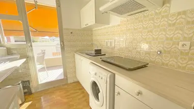 a kitchen with a washing machine on a counter at La Couronne du Cros in Cagnes-sur-Mer