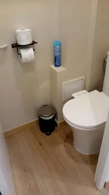 a bathroom with a white toilet and a trash can at Renovated Apartment Near the Beach in Nice