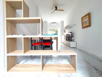 a room with wooden shelves and a red chair at GARDEN LEVEL nearby beach in Nice