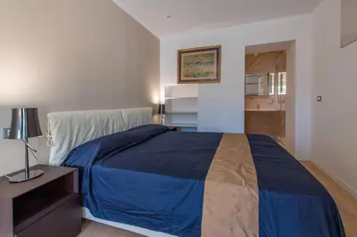 a bedroom with a bed with a blue blanket at Sea view, vue sur la mer Port De Nice - Appartement de charme 2 P in Nice