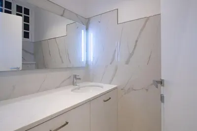 a white bathroom with a sink and a mirror at Sea view, vue sur la mer Port De Nice - Appartement de charme 2 P in Nice