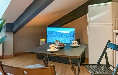 a table with two cups on it next to a refrigerator at Nice Apartment In Nice With Wifi in Nice
