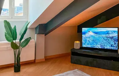 a living room with a flat screen tv and a staircase at Nice Apartment In Nice With Wifi in Nice