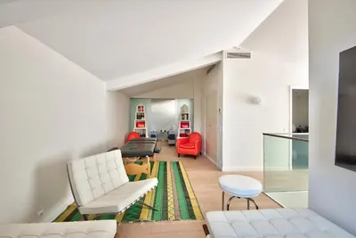 a living room with white furniture and red chairs at Villa Mont Boron, vue mer exceptionnelle in Nice