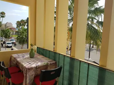 a table and chairs on a balcony with a view of a street at Nice & Les Cypres in Nice