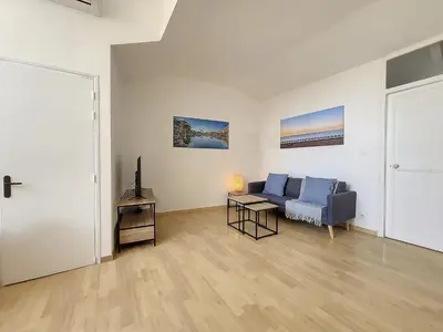 a living room with a blue couch and a table at Nestor&Jeeves - CITY BREAK - Central - Very close sea in Nice