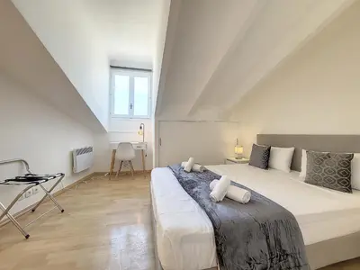 a bedroom with a large bed and a desk at Nestor&Jeeves - CITY BREAK - Central - Very close sea in Nice
