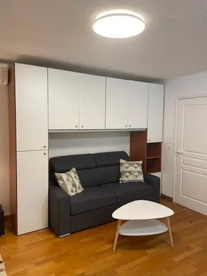 a living room with a couch and a table at Studio Centre Ville in Nice