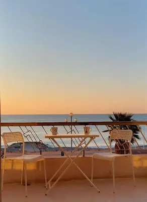 a balcony with a table and chairs and the ocean at Nice Promenade des Anglais Vue Mer in Nice