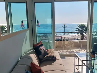 a couch in a room with a view of the ocean at Nice Promenade des Anglais Vue Mer in Nice