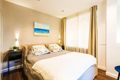 a bedroom with a bed and a window at LE MAY AP4338 By Riviera Holiday Homes in Villefranche-sur-Mer