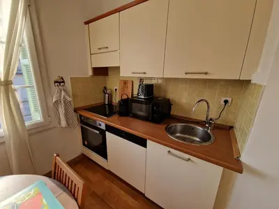 a small kitchen with a sink and a microwave at Le Michelangelo - Place Masséna in Nice