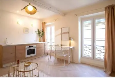 a kitchen with a table and chairs in a room at 2 pièces vieux Nice vue coulée verte in Nice