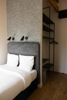 a bedroom with a large bed with white pillows at Centrum Nice in Nice