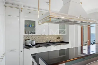 a white kitchen with a sink and a stove at Luxury apartment with sea view on the first line Promenade des Anglais in Nice