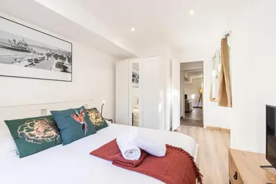 a bedroom with a white bed with towels on it at Spacious 2 Bdr Old Town Heart in Nice