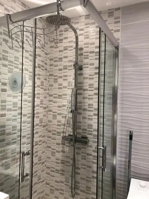 a shower with a glass door in a bathroom at Charmant studio à Cros de Cagnes in Cagnes-sur-Mer