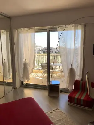 a living room with a view of a balcony at Charmant studio à Cros de Cagnes in Cagnes-sur-Mer