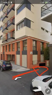 a car parked in a parking lot in front of a building at Charmant Studio à proximité du Port de Nice in Nice