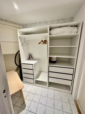 a walk in closet with white shelves at Negresco Residence Apartment with AC Promenade des Anglais in Nice