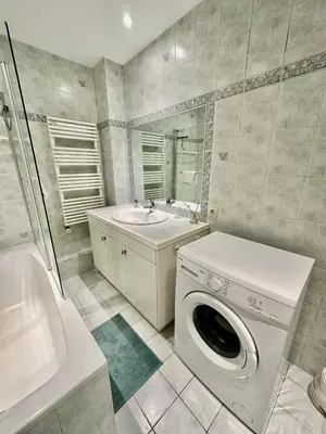 a bathroom with a washing machine and a sink at Negresco Residence Apartment with AC Promenade des Anglais in Nice